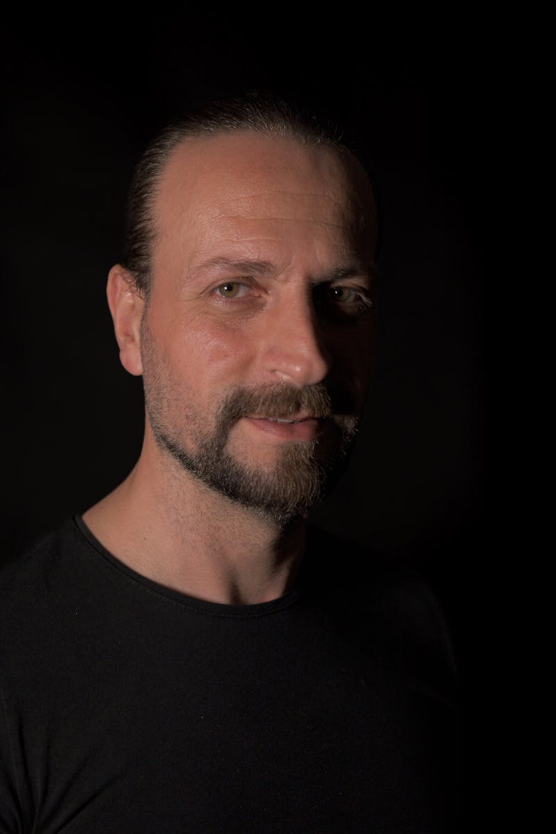 A dramatic portrait of a man in low light creating a moody atmosphere.